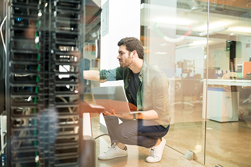 Technician reviewing secure video archive servers